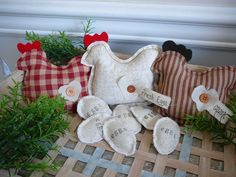 three stuffed animals sitting on top of a table next to some plants and other decorations