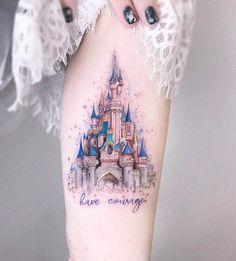 a woman's leg with a castle tattoo on it and the words live caring written in blue ink