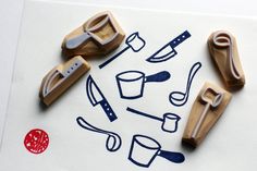 some rubber stamps are laying on top of a piece of paper with scissors and other items