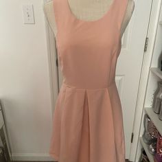 This Gorgeous Dress Is Sleeveless With Cutouts On The Side And Back. It Is A Well Made Dress Of Polyester/Spandex Blend And Zips Up The Back. Dress Falls Right About The Knee And Is Lined. Dress Is A Blush/Peach Color. Dress Is A Size Medium And New With Tags. Sleeveless Pleated Mini Dress For Day Out, Sleeveless Pleated Sundress For Day Out, Pink Pleated Sleeveless Fitted Dress, Pink Fitted Pleated Sleeveless Dress, Pink Fitted Sleeveless Pleated Dress, Sleeveless Stretch Pleated Mini Dress, Sleeveless Pleated Mini Dress For Spring, Pleated Sleeveless Stretch Mini Dress, Spring Sleeveless Pleated Mini Dress