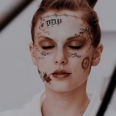 a woman with her face painted in black and white