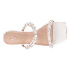 The Calissa slide sandal dazzles with faux pearls and sparkling stones that embellish its design, adding a touch of glamour to your look. Featuring a high block heel and a contemporary square-toe silhouette, this sandal exudes sophistication and style. Perfect for dressing up dresses and skirts, the Calissa slide sandal offers both elegance and comfort. Elevate your ensemble with this chic accessory, ensuring you stand out with confidence and flair at any special occasion or event. Embellished White Synthetic Sandals, White Open Toe Sandals With Rhinestones, White Synthetic Sandals With Rhinestones, White Rhinestone Open Toe Sandals, White Rhinestones Open Toe Sandals, White Flat Heel Sandals For Evening, White Embellished Open Toe Sandals, Glamorous Pearl-embellished Sandals For Spring, White Embellished Flat Heel Sandals