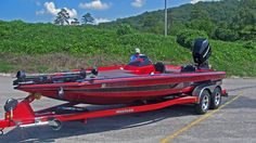 a red and black boat parked in a parking lot