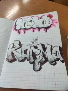 an open notebook with graffiti written on it