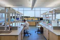 a man working in a lab with lots of counter space