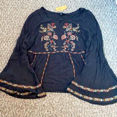 American Eagle Bell Sleeve Blouse. New With Tags Size Xl Beautiful Flower Embroidery Black V-neck Blouse With Floral Embroidery, Black V-neck Tops With Floral Embroidery, Bohemian Rayon Tops With Floral Embroidery, Bohemian Rayon Top With Floral Embroidery, Black Long Sleeve Embroidered Top For Summer, Black Long Sleeve Embroidered Top, Black Embroidered Long Sleeve Top For Summer, Fall Black Top With Floral Embroidery, Black Peasant Top With Floral Embroidery