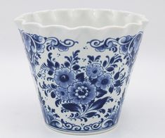 a blue and white vase with flowers on it