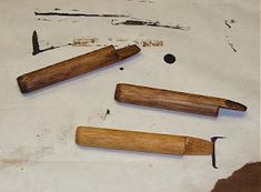 three wooden tools are laying on the table