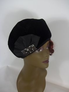 - 1920's, beret, French, beret, hat, - asymmetric beret - one side is taller, - velvet, black, poly - lined with black silky poly lining - black stretch elastic hatband, - brooch - Art Deco style metal and crystals bar with black grosgrain ribbon fan. Additional 3 tiny safety pins hold the ribbon fan in place on inside, - hand wash cold or dry clean - sizes: S,M,L Your head circumference: 21.5 inches - size S. 22.5 inches - size M. 23.5 inches - size L. SHIPPING is free in the USA. Processing ti Beret Women, Beret Fashion, French Beret Hat, Black Beret, Brooch Art, French Beret, Black French, Safety Pins, Beret Hat