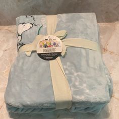 a blanket that is wrapped in blue and has a cartoon character on it