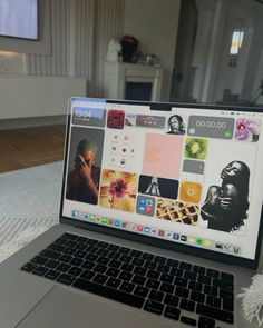 an open laptop computer sitting on top of a white bed covered in pillows and blankets