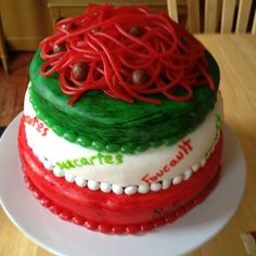 a cake decorated with red, green and white icing