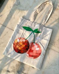 a bag with two cherries painted on it