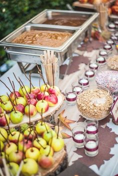 a table topped with lots of apples and desserts next to other foods on plates