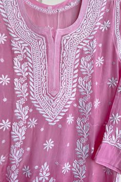 This crepe silk kurta in a soft, pink color is a stunning addition to your wardrobe. Adorned with intricate hand embroidery, it is a one-of-a-kind piece that is sure to turn heads. Complete the look with white straight pants and a white dupatta for a classic, traditional ensemble. 46" length Long sleeves 20" Round neck Crepe silk Side slits Dry clean Chikankari embroidery Hand embroidered Fit: True to sizeInside Margin: NoTouch and Feel: Soft and ComfortableDispatched in 1-3 business days White Straight Pants, Lucknowi Kurta, White Dupatta, Patiala Salwar Suits, Chikankari Embroidery, Chikankari Kurta, Bridal Dupatta, Phulkari Dupatta, Chikankari Suits