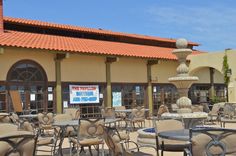 there are many chairs and tables outside the building