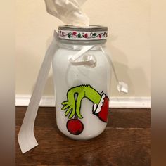 a glass jar with a tissue paper dispenser on it