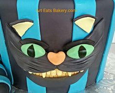 a close up of a cake with a cat face on it