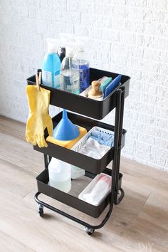 a black cart with cleaning supplies on it