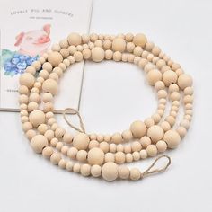 three wooden beads on a white surface next to a book