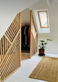 an open door leading to a bedroom with a potted plant on the floor next to it