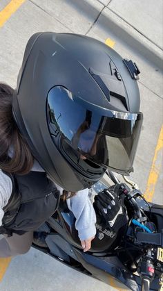 a person wearing a helmet sitting on a motorcycle