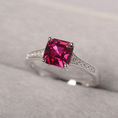 ◆ Hand-finished in Sterling sliver, this piece features a Asscher shaped ruby. Clear zirconia stones decorate half of the ring shank. A piece of classic, it is suitable for engagement, party, daily occasion. ◆ Production Description: Main stone Type: Lab Ruby Main Stone Shape: Asscher Main Stone Size: 7*7mm Side stone: CZ Metal: 925 Sterling silver - Other options available in the drop down menu ◆ Customization: √Free for Add Engraving √Other Metal Type Available √Other Gemstones & Shapes Av Gift Ruby Ring With Center Stone, Fine Jewelry Rings With Lab-created Ruby And Accent Stones, Gift Ring With Brilliant Cut Lab-created Ruby, Brilliant Cut Lab-created Ruby Ring For Gift, Gift Rings With Brilliant Cut Lab-created Ruby, Fine Jewelry Ruby Ring With Cubic Zirconia For Promise, Emerald Cut Ruby Ring With Accent Stones As Gift, Ruby Birthstone Ring With Accent Stones For Promise, Lab-created Ruby Gemstone Ring For Promise