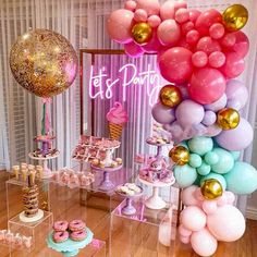 a table topped with balloons and desserts