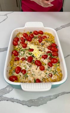 a casserole dish with tomatoes and cheese