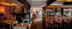 the inside of a restaurant with wooden tables and chairs