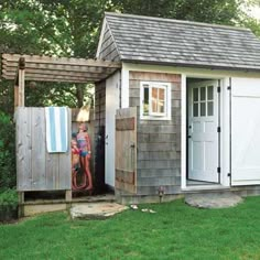 a small shed with an open door on the side and a towel hanging from it's roof