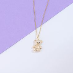 Wrap yourself in the comforting embrace of our Teddy Bear Necklace, a heartwarming accessory that symbolizes love, comfort, and companionship. This necklace showcases a meticulously crafted teddy bear pendant, showcasing intricate details and capturing the endearing nature of these cuddly friends. Whether worn as a symbol of emotional support or a cherished gift for someone special, our Teddy Bear Necklace is a sophisticated choice that seamlessly blends symbolism with timeless style. - Made in Bear Design Pendant Jewelry As Gift, Teddy Bear Necklace Aesthetic, Teddy Bear Bracelet Gold, Bear Design Pendant Jewelry For Gifts, Bear Necklace Simple, Bear Design Pendant Jewelry Gift, Teddy Bear Necklace, Teddy Bear Necklace Gold, Teddy Bear Pendant