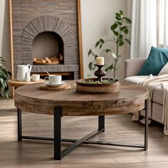 a living room with a coffee table in the middle and a fireplace in the background