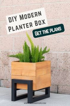 a planter box sitting on top of a sidewalk next to a brick wall with a sign that says diy modern planter box get the plans