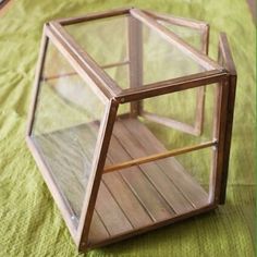 a small glass box sitting on top of a bed