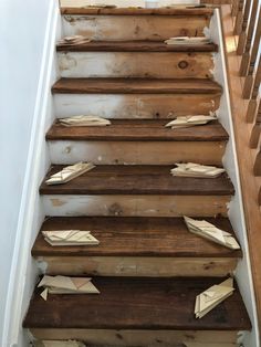 some paper airplanes are on the stairs in this house that needs to be cleaned up