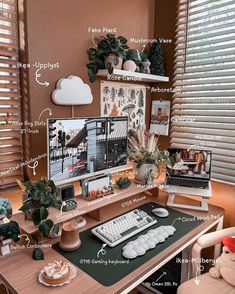 a desk with a computer, keyboard and plant on it