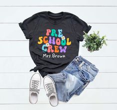 "Preschool Teacher Shirt, Custom Preschool Shirt For Teacher T Shirt, Personalized Teacher Tee, Cute Preschool Crew T-Shirt for Teacher Gift Hi, Welcome to FashionxTee Our soft and comfortable shirts are printed, pressed and shipped to you from our boutique. Enjoy your shopping!🛍️  ✔️Please make sure you check our size cards before you place your order. 📏 ✔️Please send me a message for all your questions and suggestions. It is my pleasure to assist you! **Group t-shirts are not sold as a set. Prek Class Shirts, Preschool Tshirt Ideas Teacher Shirts, Preppy Short Sleeve T-shirt For School, Preppy Short Sleeve School T-shirt, Preppy Letter Print School Top, Preschool Shirts For Teachers, Preschool Teacher Shirts, Preschool Shirts, Prek Classroom