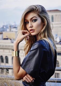 a woman posing for a photo with her hand on her chin