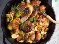 a skillet filled with chicken and vegetables