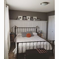 a bedroom with a bed, nightstands and pictures on the wall above it's headboard