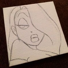 a drawing of a woman's face is shown on a piece of white paper