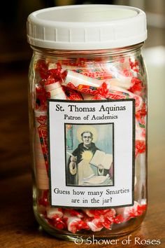 a glass jar filled with red and white candies