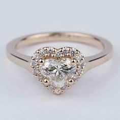 a heart shaped diamond ring with diamonds around it