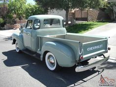 an old pick up truck is parked on the street