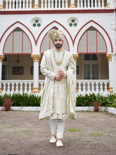 a man in a white outfit standing outside