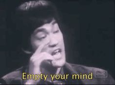 a man talking on a cell phone with the words empty your mind in front of him