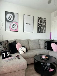 a living room filled with lots of furniture and pictures on the wall above it's coffee table