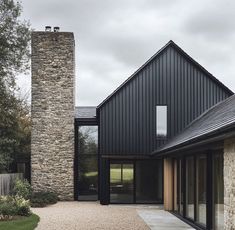 a modern house with stone and black exterior