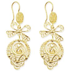 Features: Made in Portugal: Expertly crafted with traditional Portuguese artistry. 3.25" Long: Statement earrings with an elegant and eye-catching length. Intricate Filigree Metalwork: Features detailed and delicate filigree design, inspired by traditional Portuguese jewelry. Gold Color Finish: Bright, gold-colored metal that adds a touch of elegance to any outfit. Rancho Style: Reflects the traditional jewelry worn in Portuguese folk dances and cultural festivals. Timeless Bow Detail: Accented with a delicate bow for a charming and feminine look. Product Description: These stunning Portuguese filigree earrings capture the essence of traditional Rancho style, with intricate metalwork and a beautiful gold-colored finish. At 3.25" long, they make an elegant statement, perfect for special occ Portuguese Jewelry, Long Statement Earrings, Cultural Festival, Dance Jewelry, Filigree Earrings, Filigree Design, Bright Gold, Bow Design, Traditional Jewelry